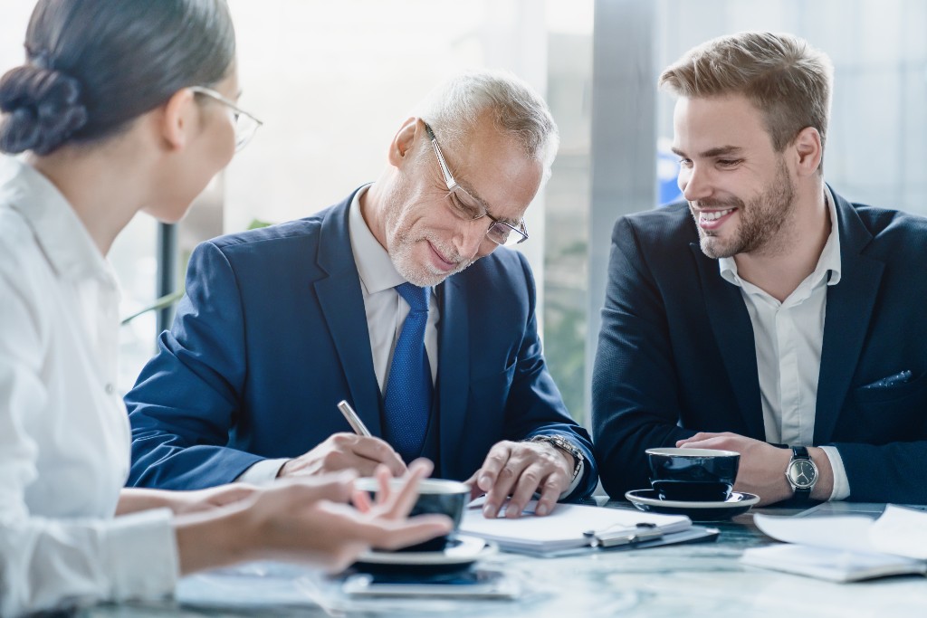 Financial services professionals reviewing and signing documents together